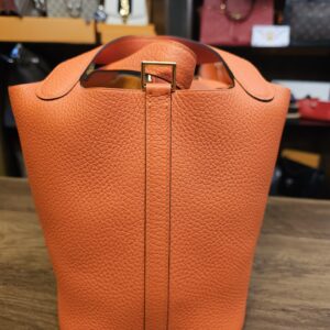 Side with the closure strap running down the center