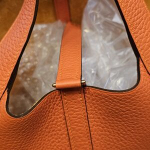 Closure strap across the open top