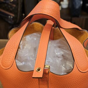 Top view with the closure strap and gold-tone stud