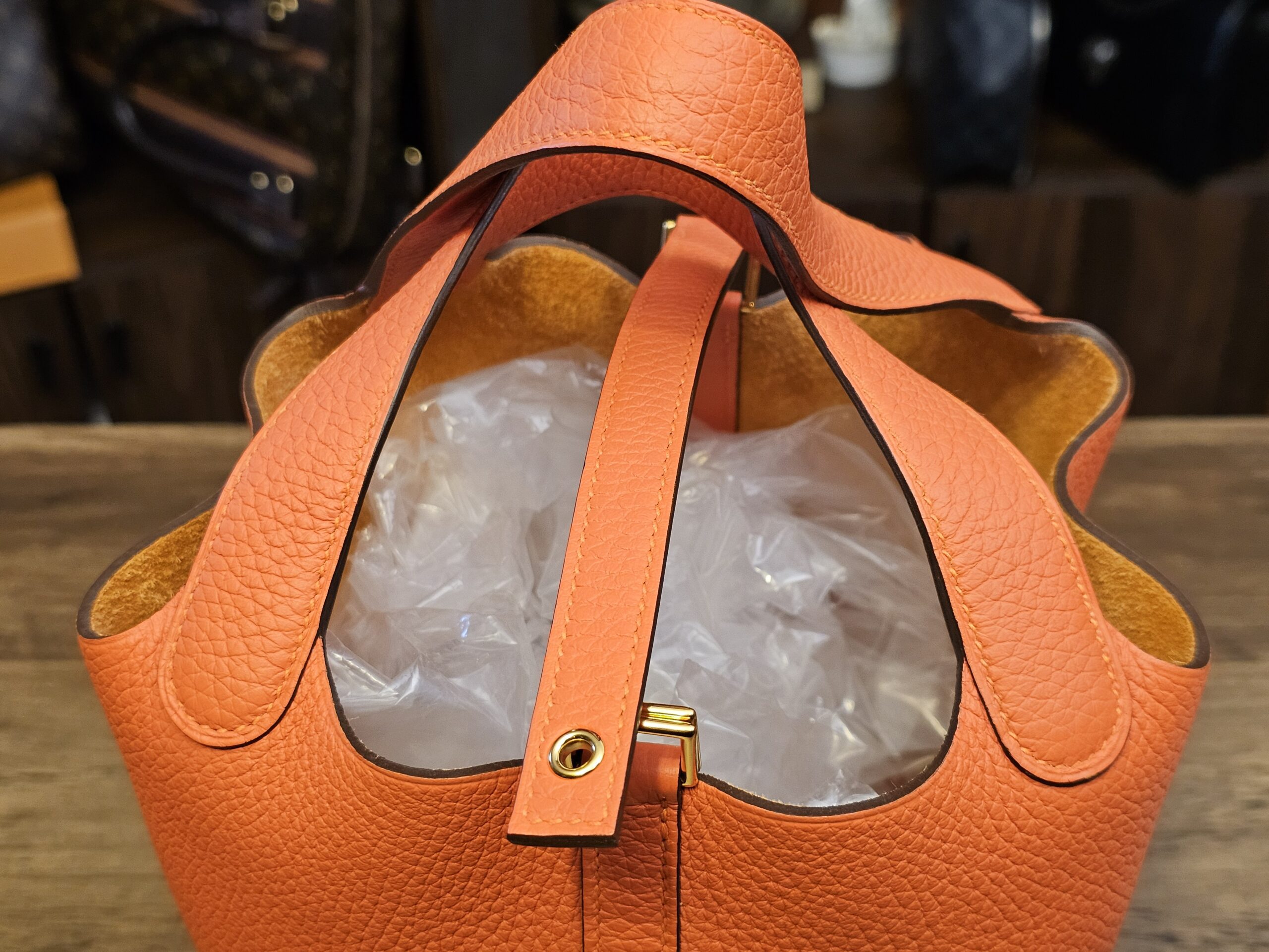Top view with the closure strap and gold-tone stud