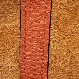 Stamp on the inner leather strap against the suede lining