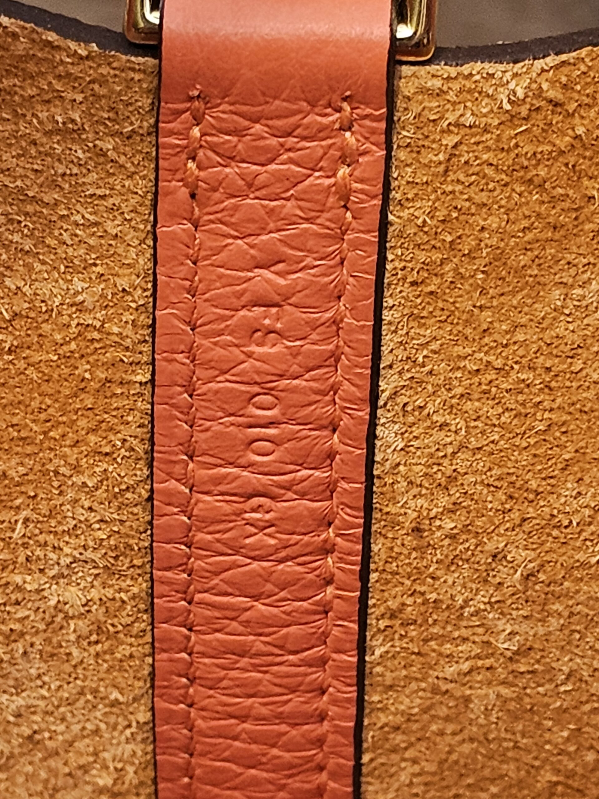Stamp on the inner leather strap against the suede lining