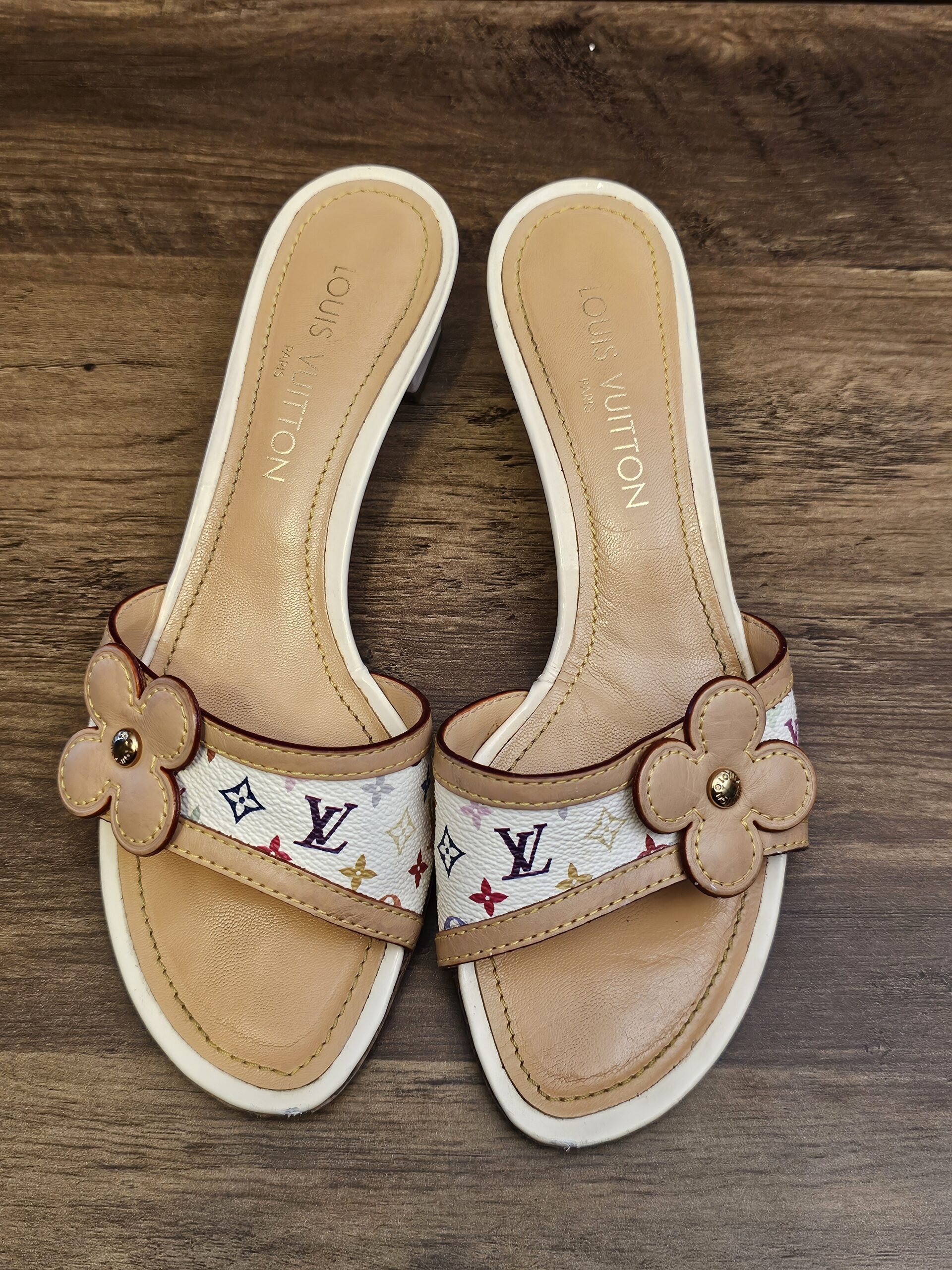 Overhead view of both mules with LOUIS VUITTON stamped insoles