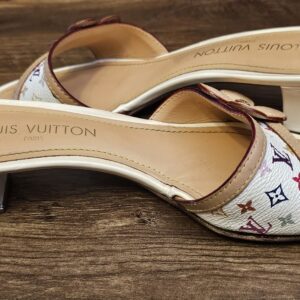 Side view of both mules showing the block heels and stamped insoles