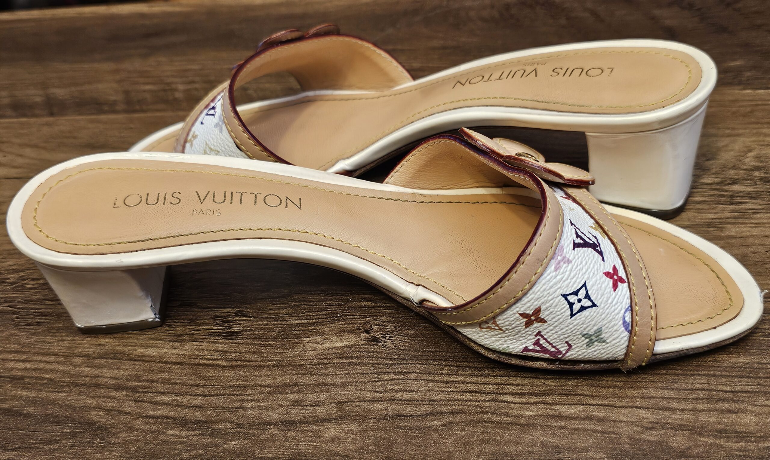 Side view of both mules showing the block heels and stamped insoles