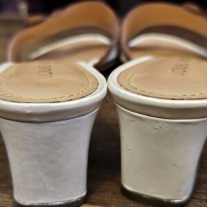 Back view of the white block heels showing scuffing