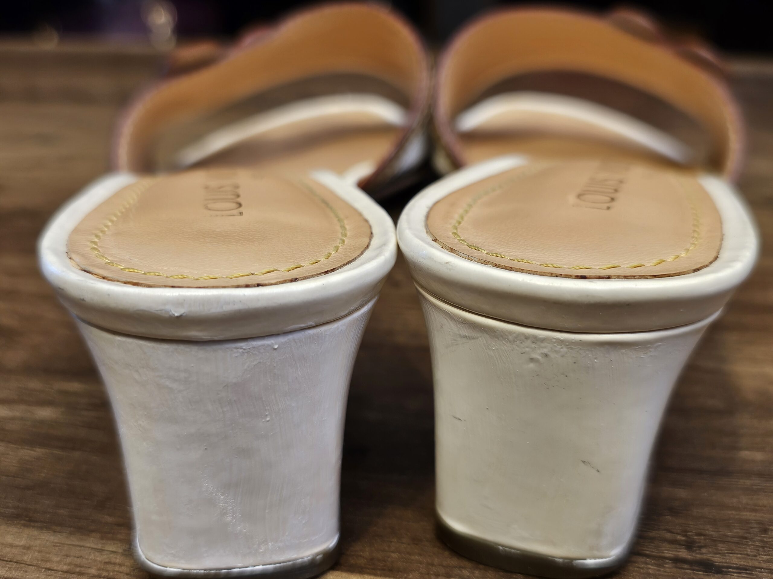 Back view of the white block heels showing scuffing