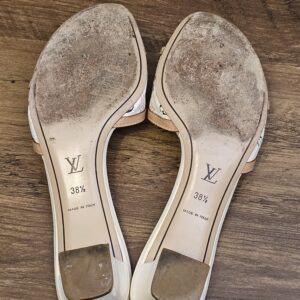 Underside of both mules showing sole wear