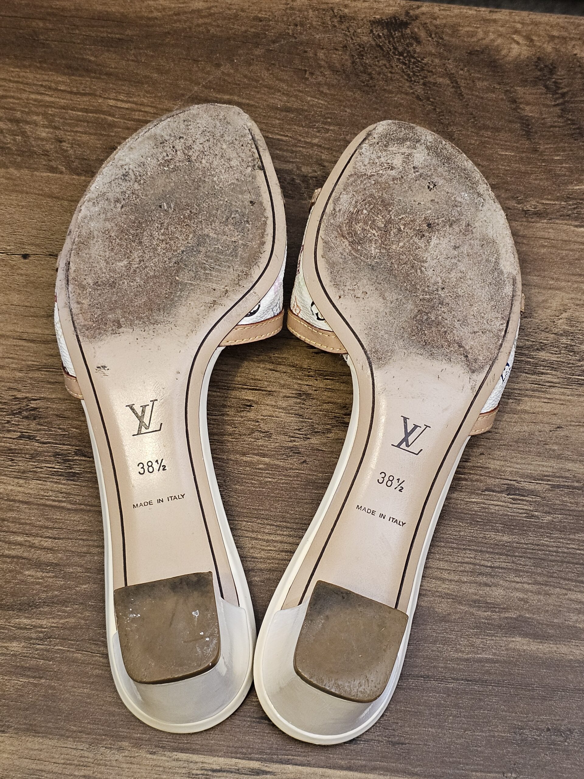 Underside of both mules showing sole wear