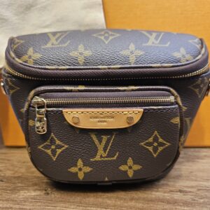 Front of the bag showing the zip front pocket with leather tab