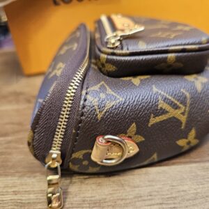 End view with a gold-tone strap ring and the front pocket