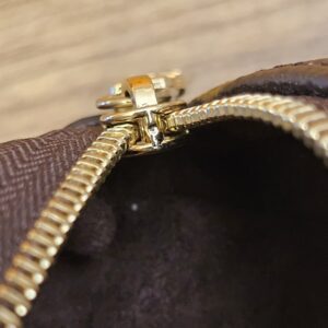 Close up of the gold-tone zip and lining