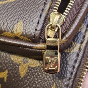 Gold-tone LV zip pull on the front pocket