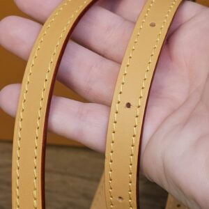 Leather strap held in hand showing the light cowhide
