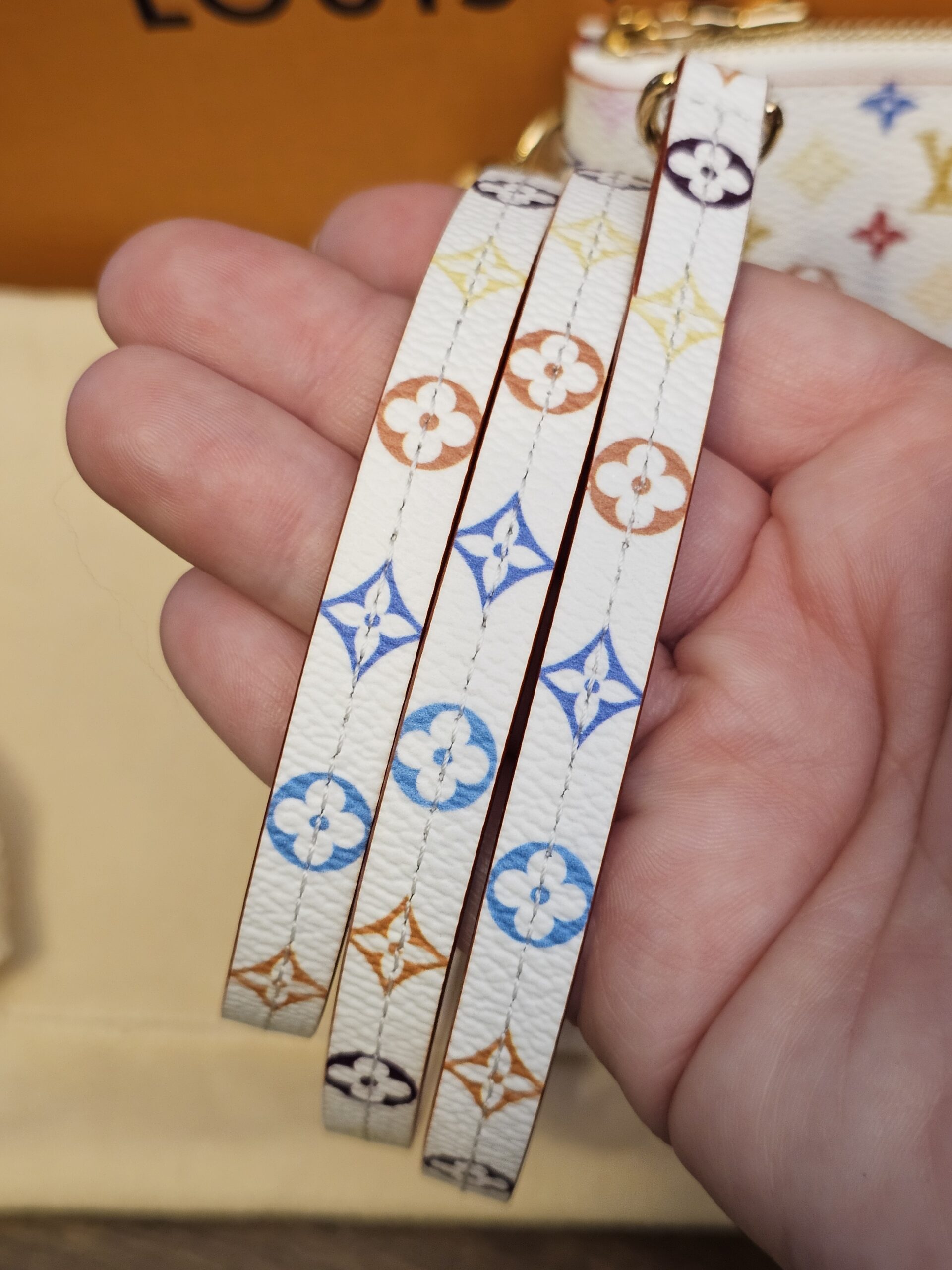 Removable Multicolor strap held in hand
