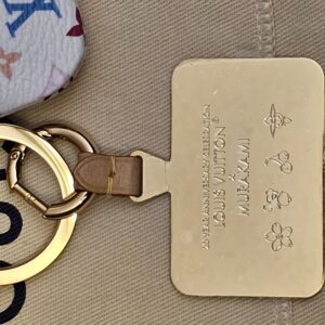 Gold-tone 20 Year Anniversary Celebration tag on its leather tab
