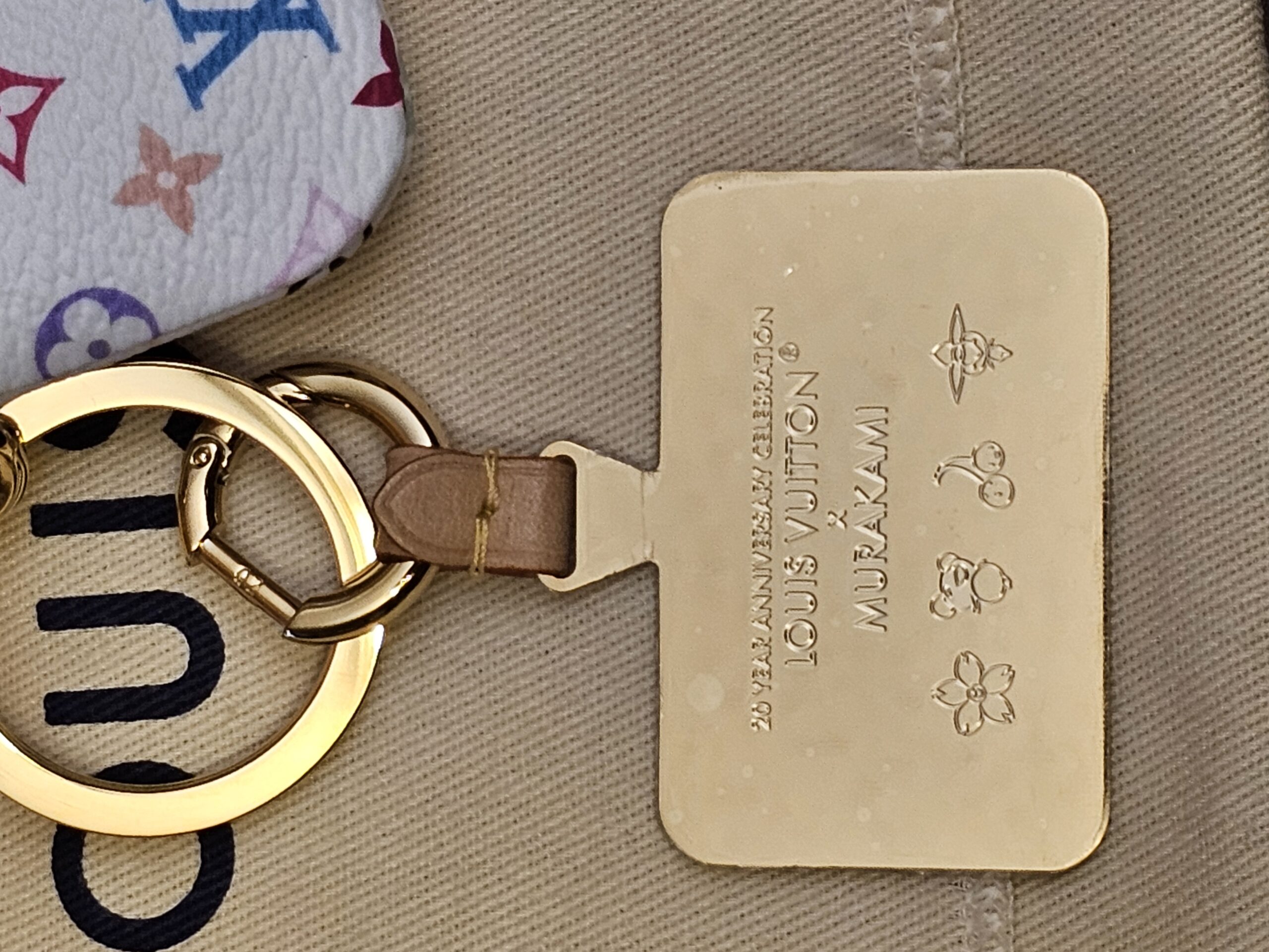 Gold-tone 20 Year Anniversary Celebration tag on its leather tab