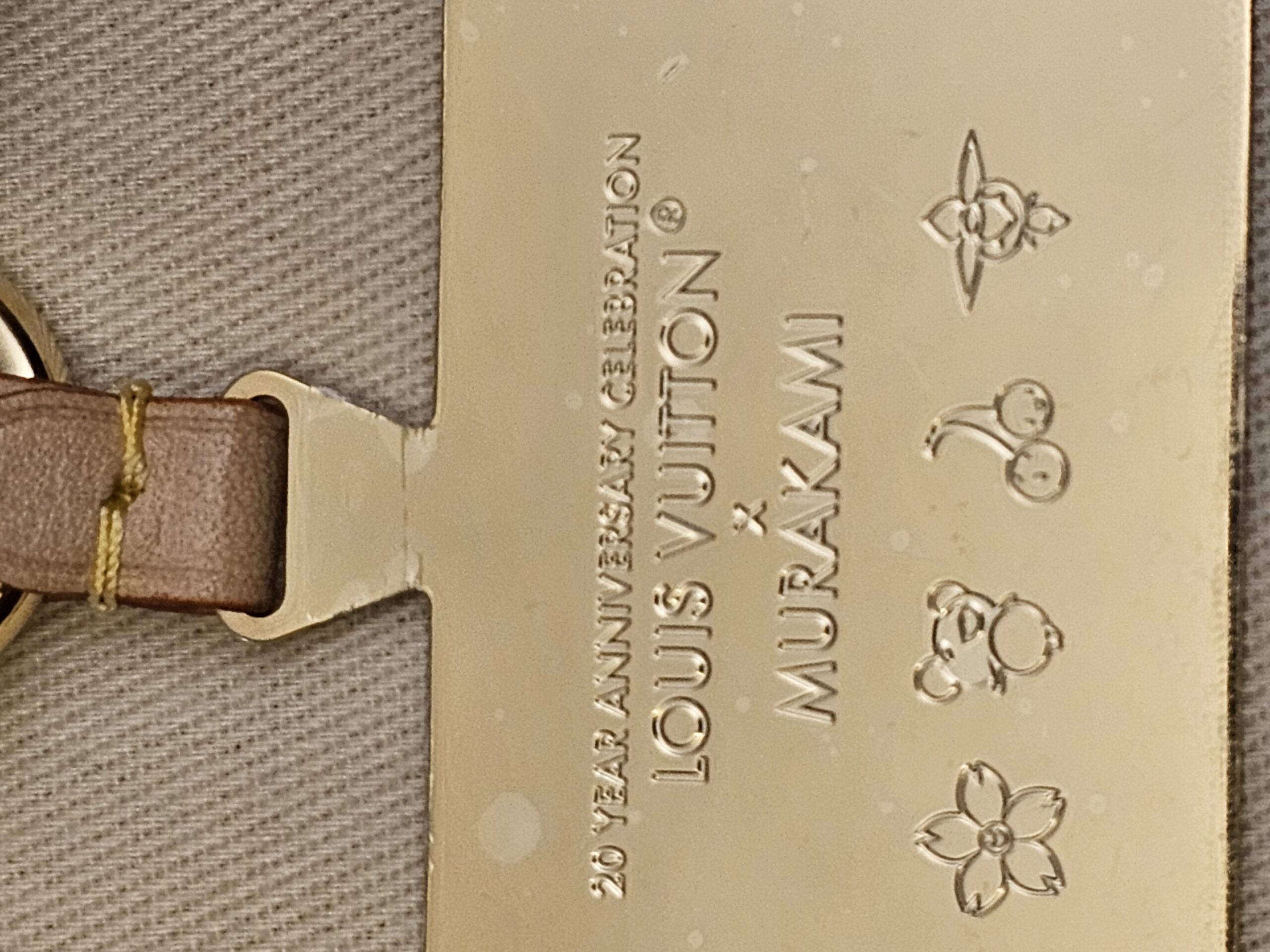 Close up of the tag reading 20 Year Anniversary Celebration Louis Vuitton x Murakami