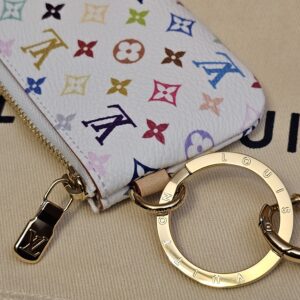 Gold-tone key ring and LV zip pull at the side