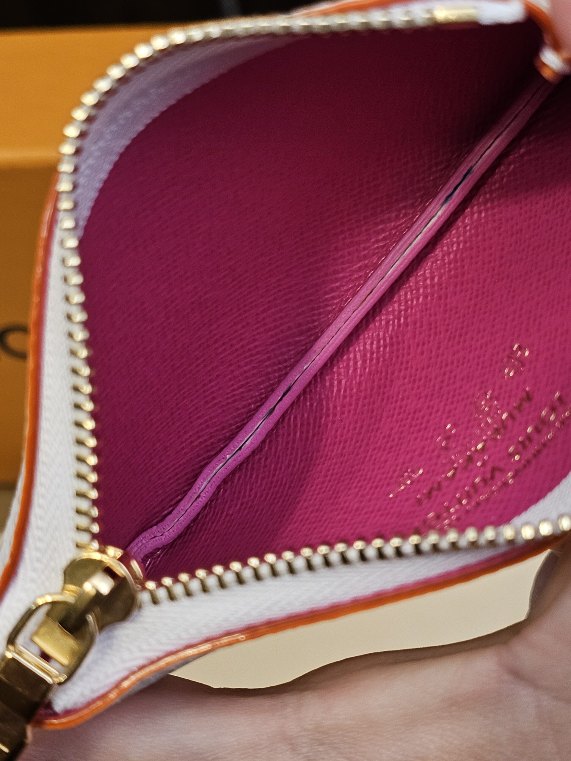 Zip open showing the bright pink interior