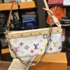 Louis Vuitton x Takashi Murakami Monogram Multicolor Pochette Accessoires White 20th Anniversary - held by its leather strap