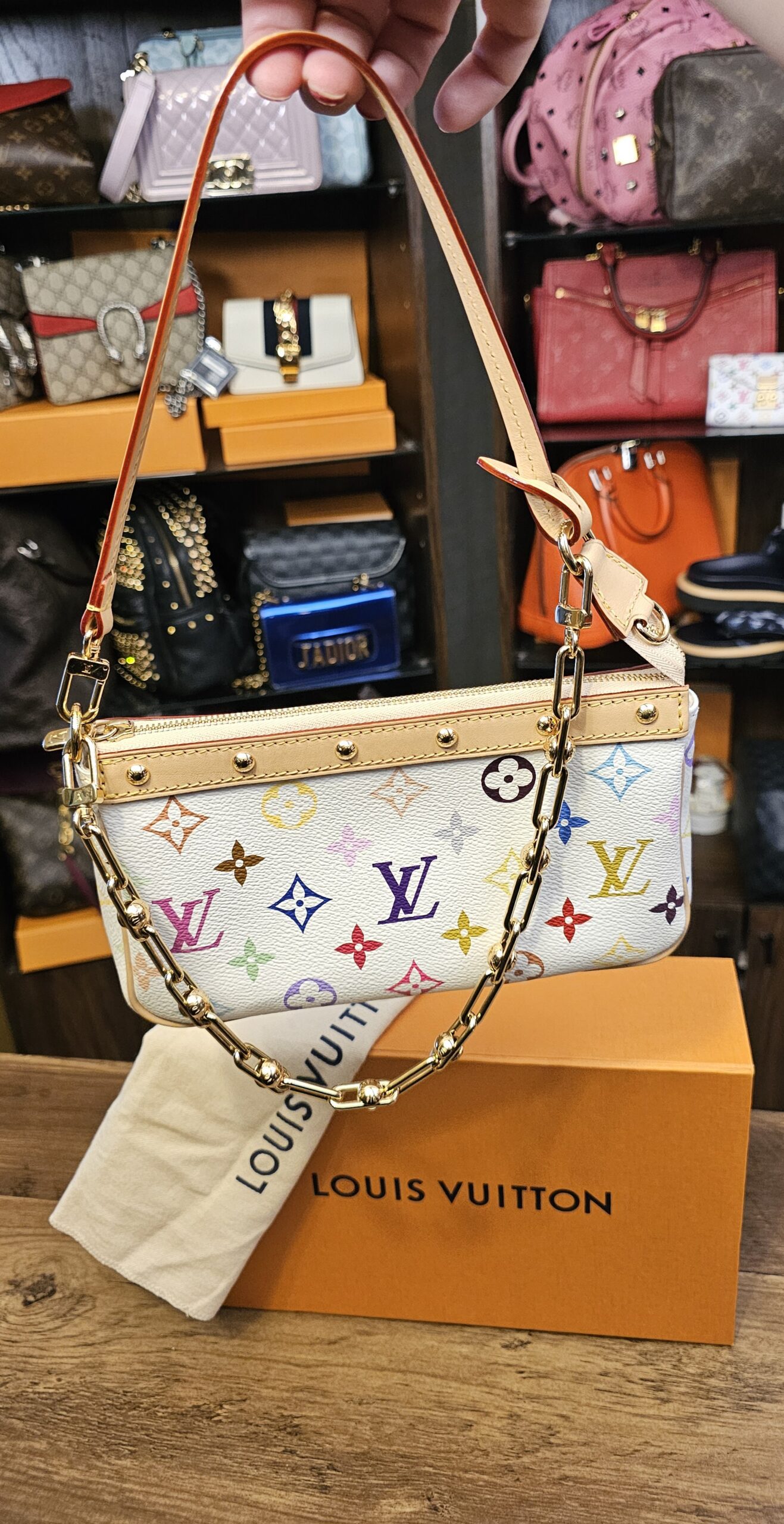 Louis Vuitton x Takashi Murakami Monogram Multicolor Pochette Accessoires White 20th Anniversary - held by its leather strap
