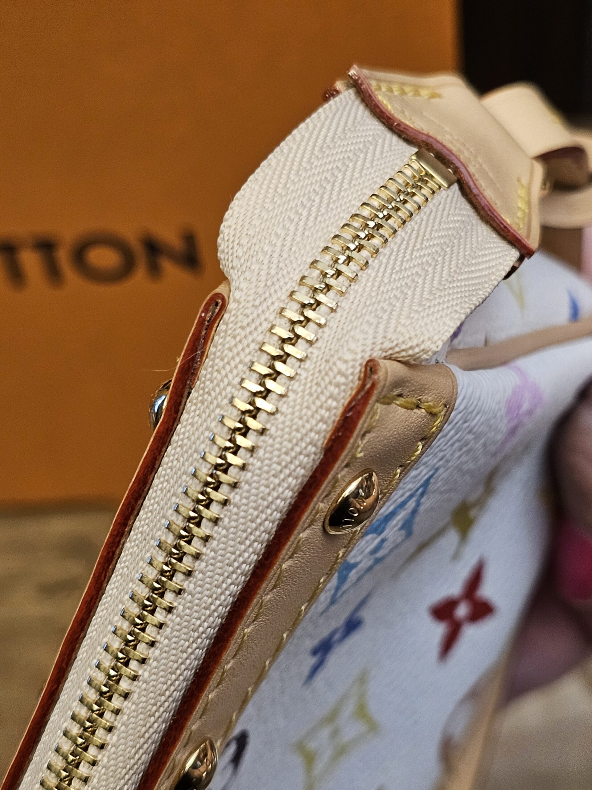 Side of the zip showing the leather tab and stud