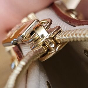 Close up of the strap clip on the gold-tone ring