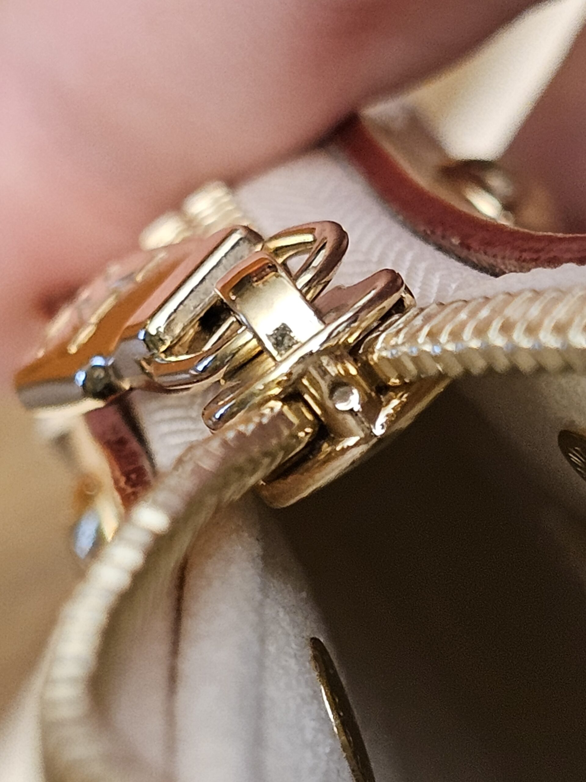 Close up of the strap clip on the gold-tone ring