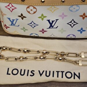 Removable gold-tone decorative chain on the dust bag