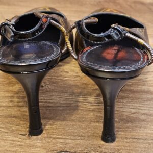 Back view of the slim heels and buckled straps