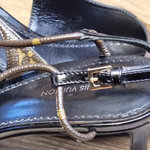 Close up of the gold-tone buckle and Monogram wrapped strap