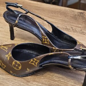 Angled side view of the pumps and their buckled straps