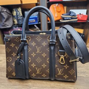 Louis Vuitton Monogram Soufflot BB Black - front view with the black leather strap and luggage tag