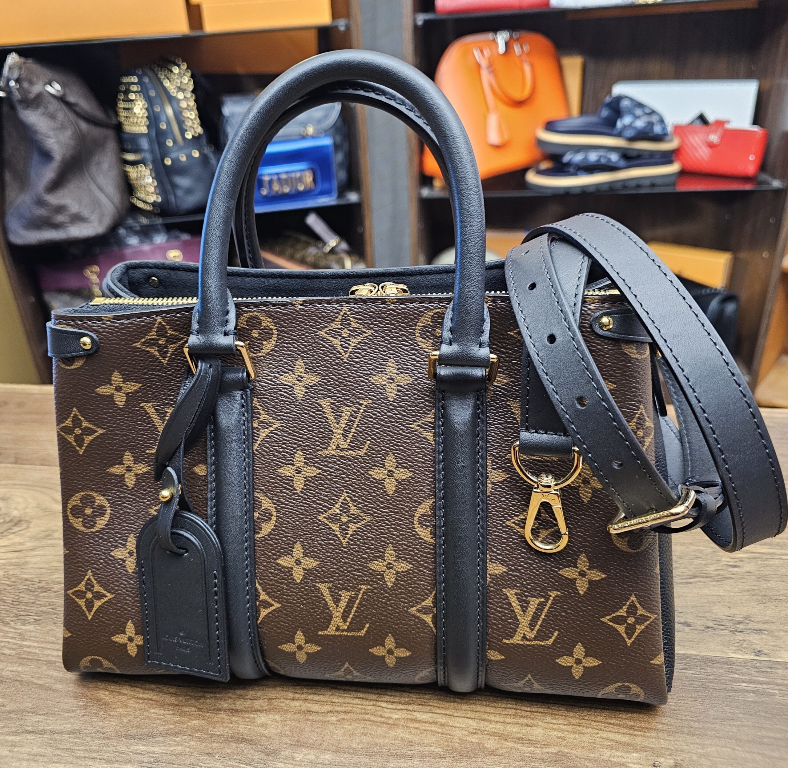 Louis Vuitton Monogram Soufflot BB Black - front view with the black leather strap and luggage tag