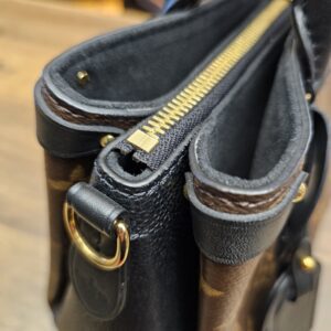 Close up of the top zip and an open side compartment