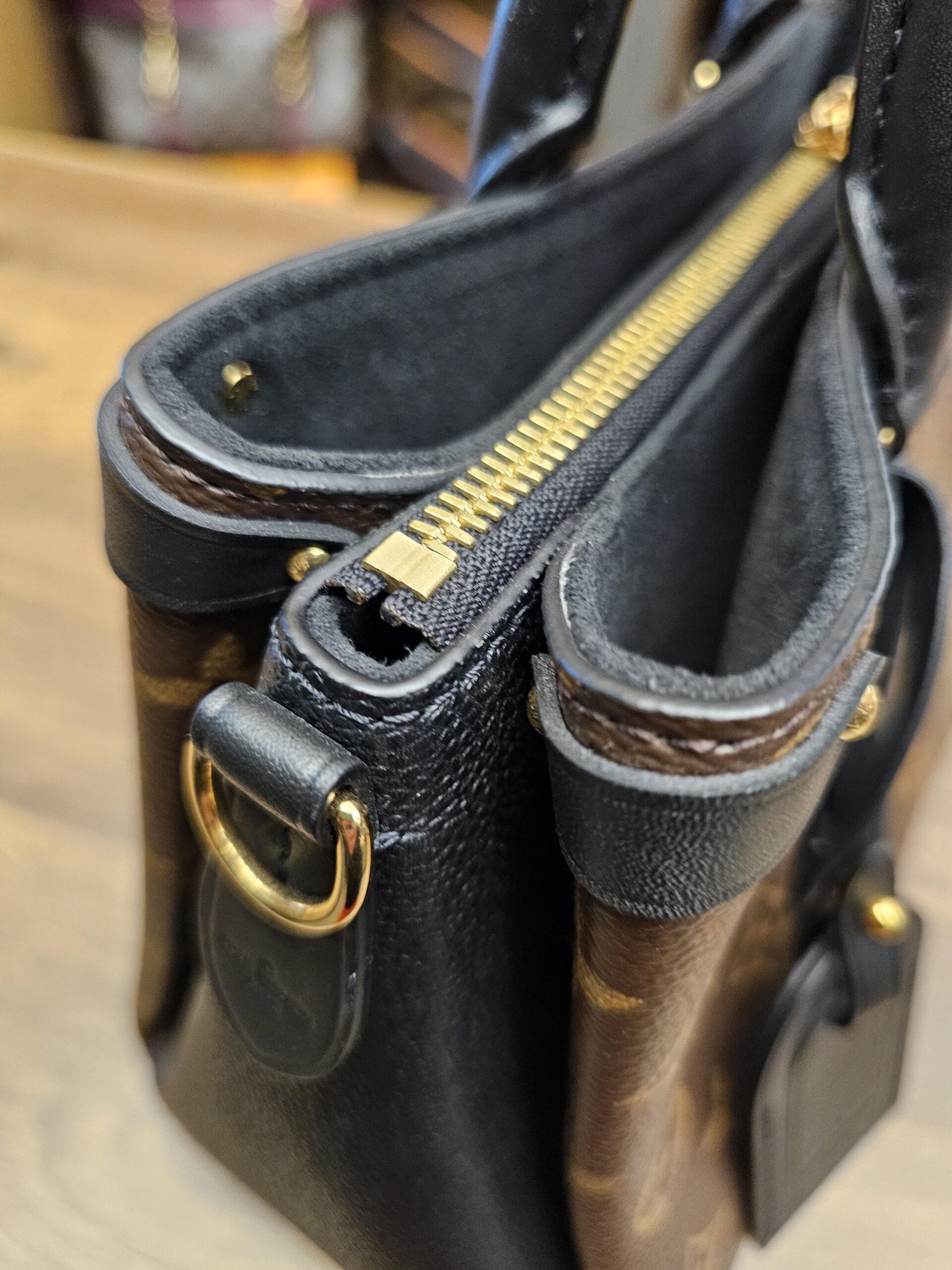 Close up of the top zip and an open side compartment