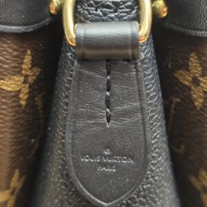 Leather side panel stamped LOUIS VUITTON PARIS below a gold-tone ring