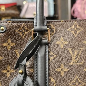 Black leather luggage tag hanging from the handle