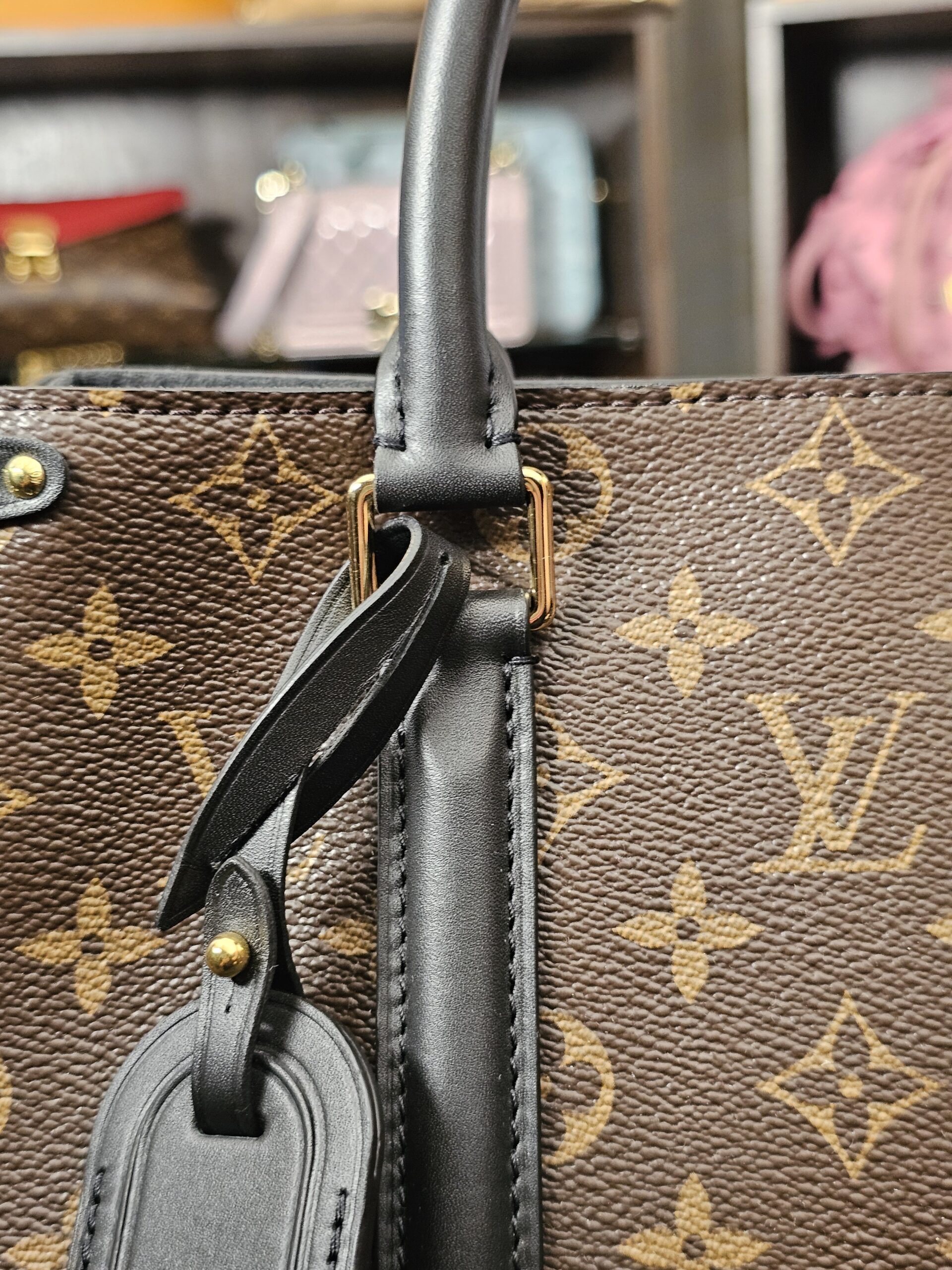 Black leather luggage tag hanging from the handle