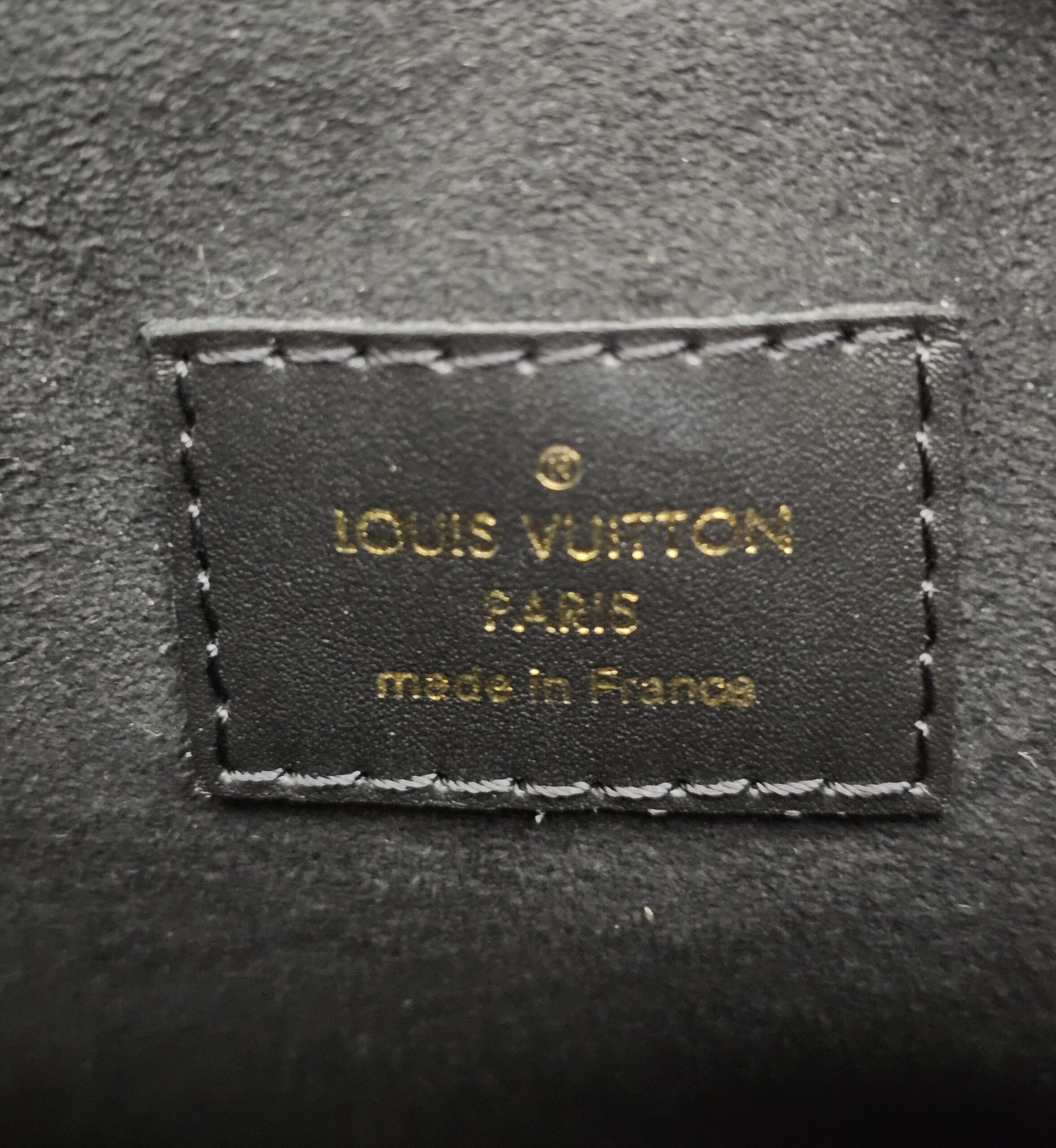 Interior heat stamp reading LOUIS VUITTON PARIS made in France