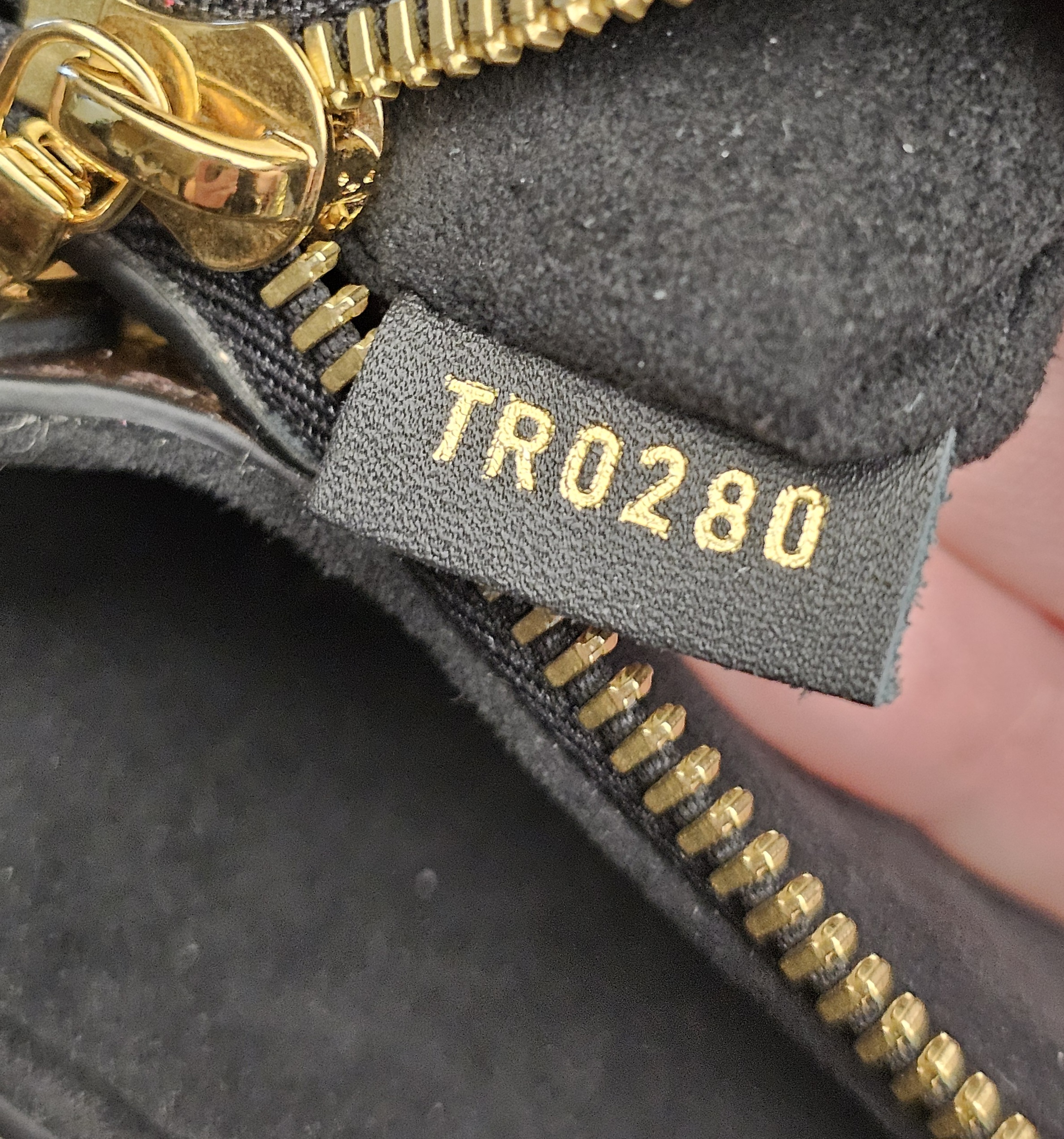 Date code TR0280 on a leather tab inside the bag