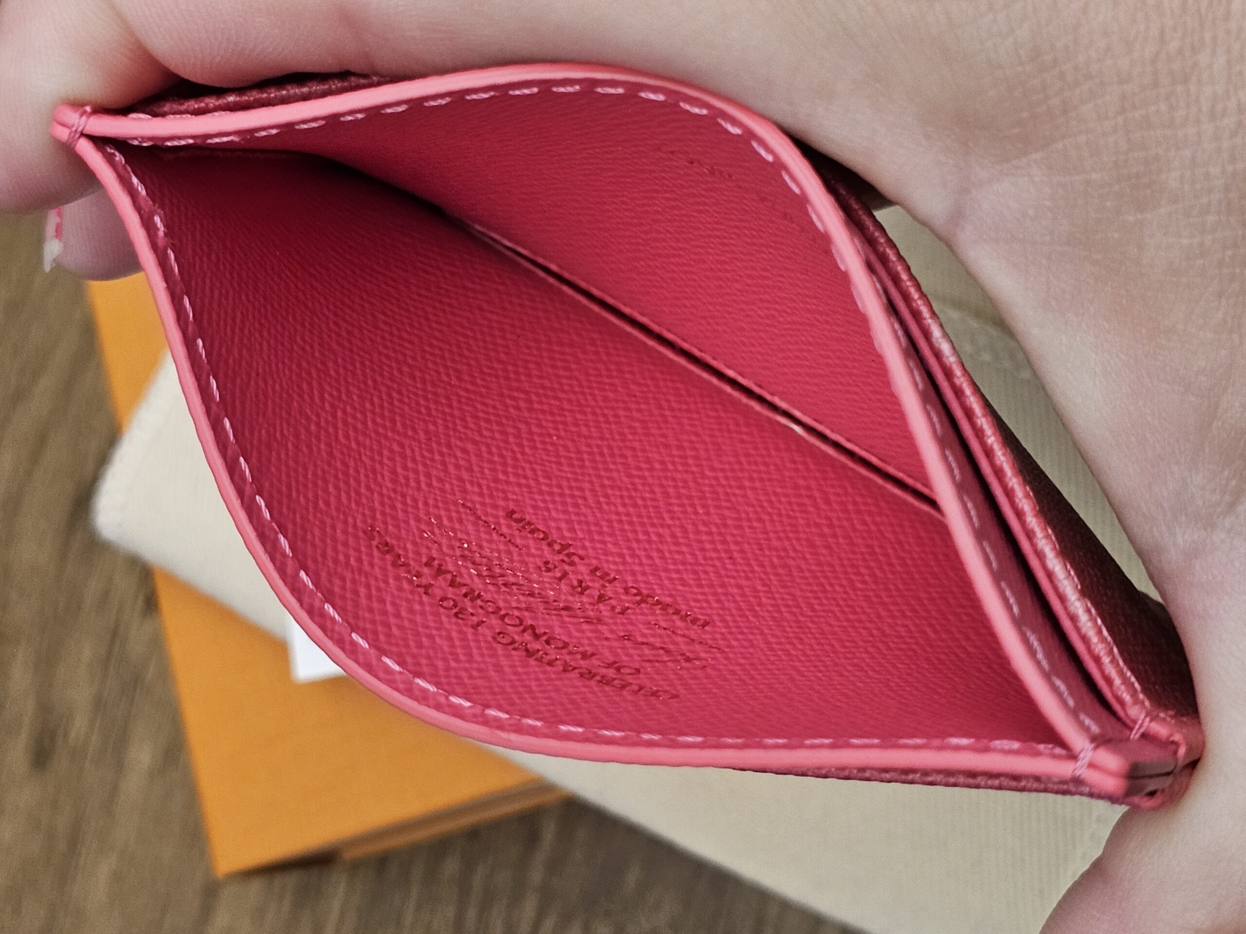 Center pocket held open showing the pink leather lining