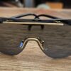 Christian Dior Vintage 2434 Shield Sunglasses Black Gold - front view of the dark shield lens and gold-tone bridge