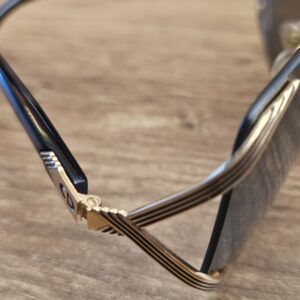 Close up of the gold-tone hinge with ribbed detailing