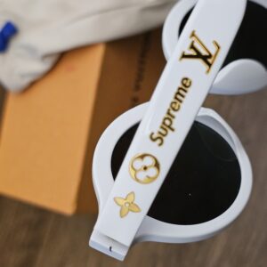 Close up of the gold-tone LV, Supreme and Monogram flower details