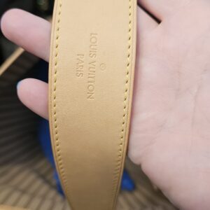 Underside of the wide vachetta shoulder strap with its stamp
