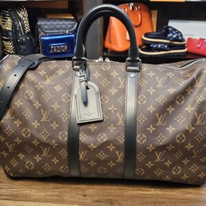Louis Vuitton Monogram Macassar Keepall Bandouliere 45 - front view with black leather trim, luggage tag and shoulder strap