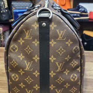 End of the bag with black leather trim and D ring