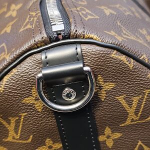 Silver-tone D ring on its black leather tab